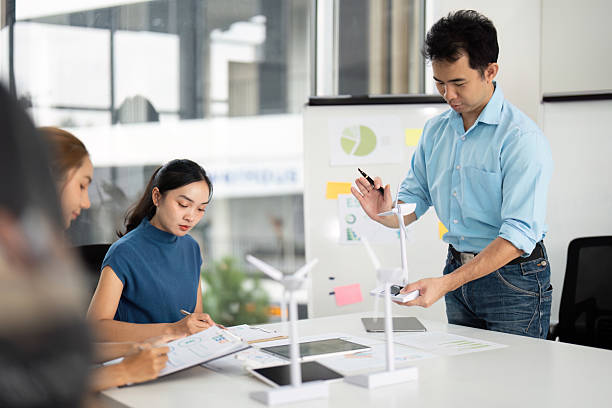 istock Sustainability and ESG. Team discussing renewable energy solutions in a modern office. 2215336624