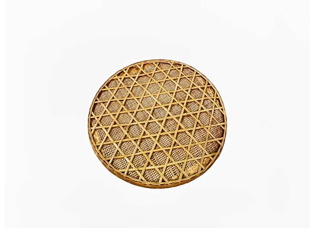 The white background in the picture is a winnowing basket woven in detail from brown bamboo with thick edges lightweight used in households to put vegetables and fruits with beautiful colorful pattern