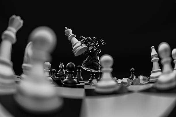 White king chess pieces destroy black king chess pieces over the chess board. Leader, plan, fight, destroy, win, lose concept.