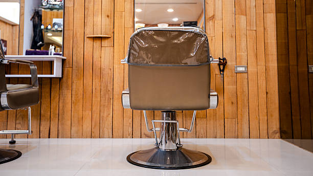 istock Upscale hair salon with polished styling chairs and mirrored interior design 2215343803
