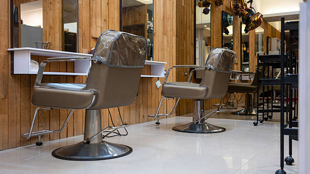 istock Upscale hair salon with polished styling chairs and mirrored interior design 2215343810
