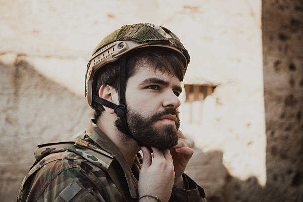 Soldier Puts On His Hat Before Scouting The Dangerous Area.