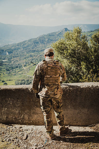 istock Young Soldier Prays Remembering His Fallen Comrade In The Battle 2215346683