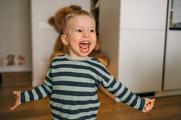 istock Happy toddler smiling joyfully at home 2215346812