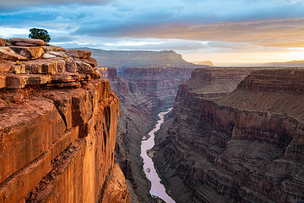 Sunrise at Toroweap Lookout on the North Rim of the Grand Canyon. This stunning overlook showcases dramatic cliffs, deep canyons, the Colorado River and golden light painting the rugged landscape, creating a mesmerizing natural wonder. Toroweap is a very remote location and very challenging to get to.