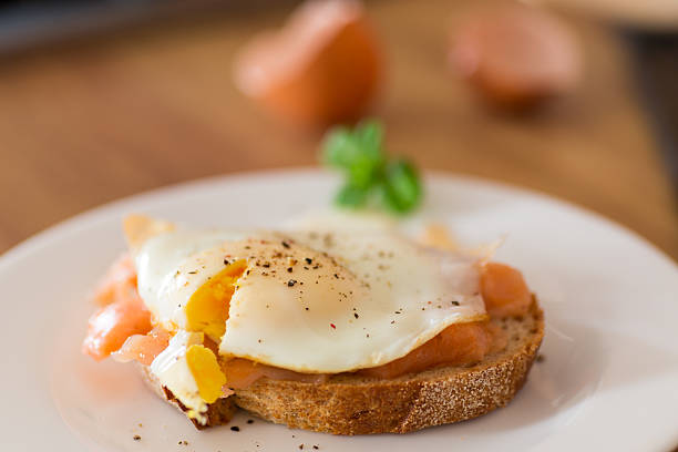 istock A slice of bread with a cooked egg and lightly salted red fish 2215349731