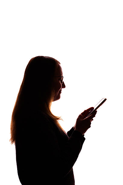 istock Silhouette of young woman using smartphone on white background 2215349741