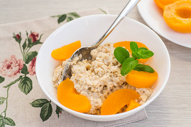 Healthy breakfast with oatmeal porridge in bowl mango. Top view.