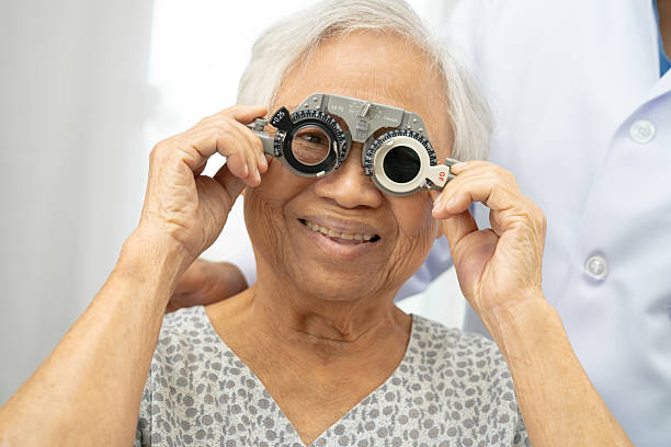 istock Asian senior woman wearing ophthalmic vision eye test and using optical trial frame. 2215351960