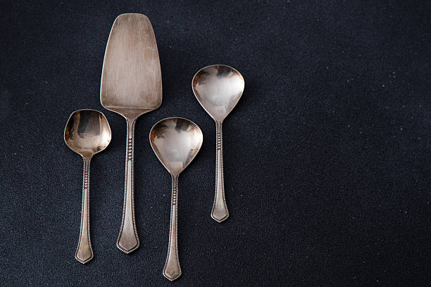 istock Elegant Silver Serving Utensils Set. Different spoons cutlery on a black background. 2215354644