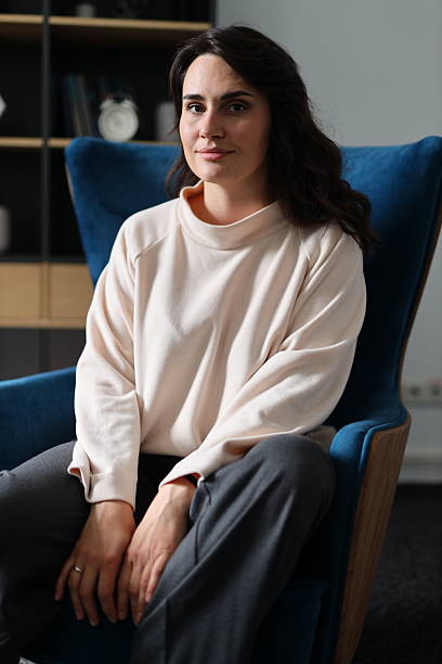 istock Young caucasian female relaxing in modern office setting 2215355957