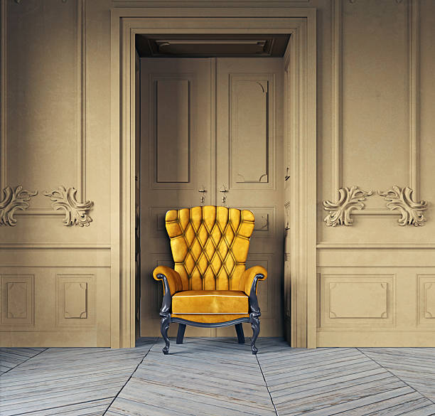 Interior of once grand historic old Palazzo Room interior with 1920's vintage antique furniture and old rugs and floors with door and light in farther room door about to open with wallpaper , all parts of an old house in Italy, an Italian Palazzo Interior but in need of love and attention , beautiful as it is moody with bright pools of light and strong dark areas much with golden glow