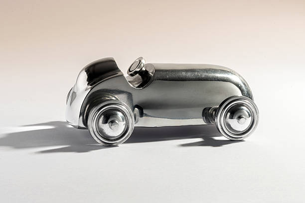 Polished aluminum miniature car from the past evoking nostalgia and elegance