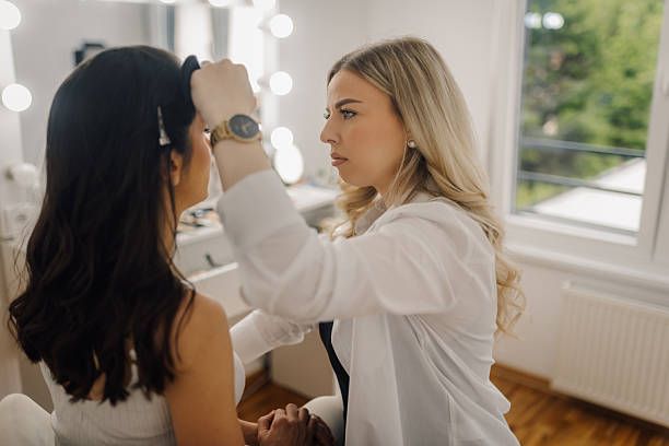 istock Professional makeup artist applying makeup on bride's face 2215363166