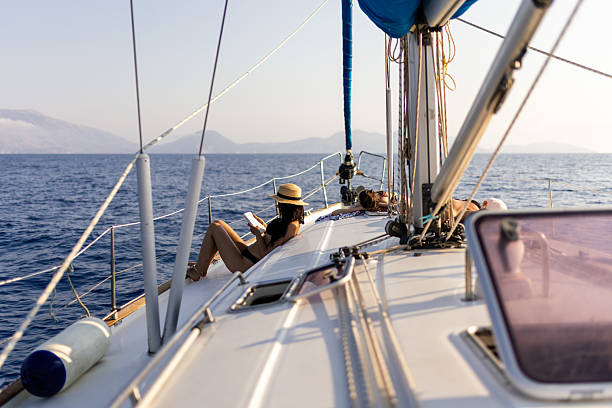 istock Three beautiful women sunbathing on a sailboat 2215364257