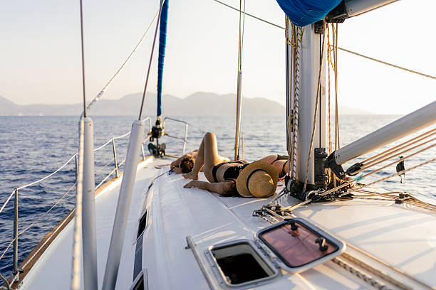 istock Three beautiful women sunbathing on a sailboat 2215364281