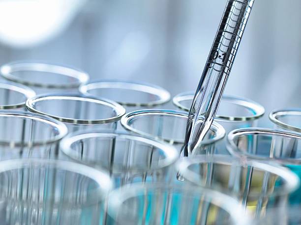 istock A precise pipette dispenses a liquid drop into a multi-well plate, a lab close-up scene. 2215364664