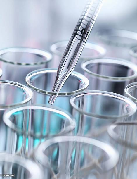 istock A precise pipette dispenses a liquid drop into a multi-well plate, a lab close-up scene. 2215364669