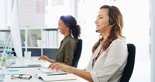 istock Headset, woman and typing with computer in call center for virtual assistance, online advice and technical support. Contact us, friendly agent and help with inbound query and network issue resolution 2215366528