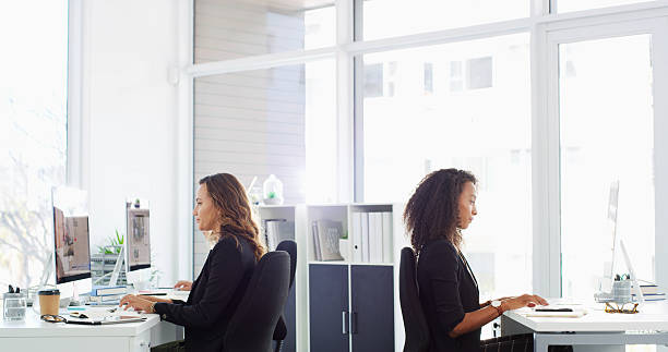 istock Business, people and typing on computer in office for property search, listing web and real estate agents. Women, coworking and online for homepage research, real estate agent information and viewing for ideas 2215366675