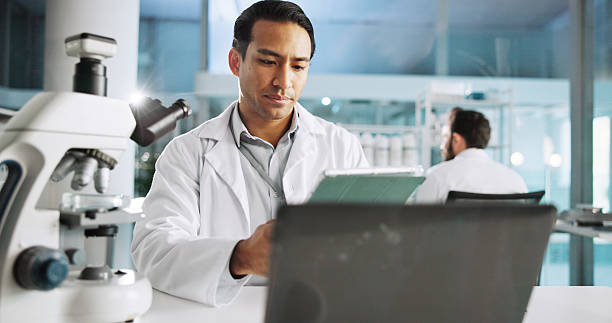 istock Tablet, science and research with man in laboratory for DNA sample, forensics investigation and healthcare. Laptop report, genetic analysis and medical test with person for pathology and clinic 2215368634