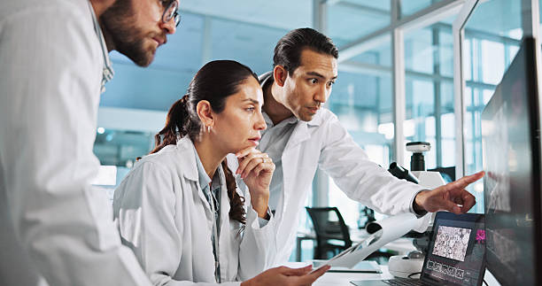 istock Teamwork, people or scientists on computer for vaccine breakthrough, clinical trial or DNA discovery. Chemistry, medical test or science research in lab with results notes, bacteria or medicine cure 2215368644