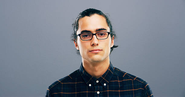 istock Glasses, mockup and portrait with man in studio for intelligence, optometry or vision. Confident, eyewear and space with serious person at optometrist for eye health appointment on gray background 2215370414