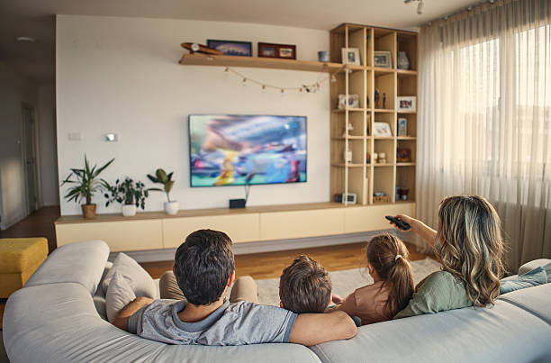 Family watching TV stock photo