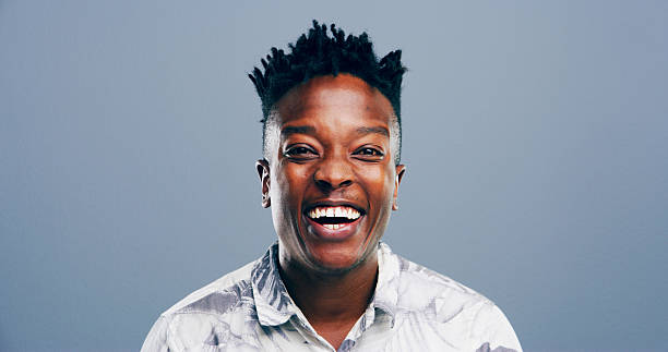 istock Black man, portrait and laughing in studio for joke, funny memory and comedy with mockup space. Model, male person and happiness with humor by blue background, satisfaction and expression for emoji 2215371205