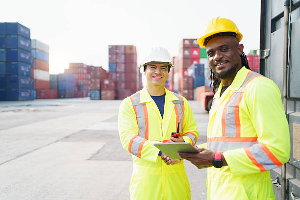istock Engineers team or shipyard officers inspecting a containers in container yard. 2215372759