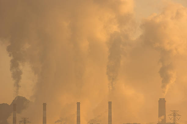 istock Air pollution from coal power plant smokestacks during golden hour 2215374172