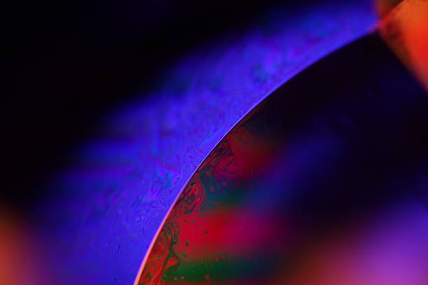 istock Purple and orange liquid surface reflection, natural phenomena 2215378996