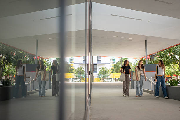 istock Three Young Women Reflected in Glass While Walking Outdoors 2215379070