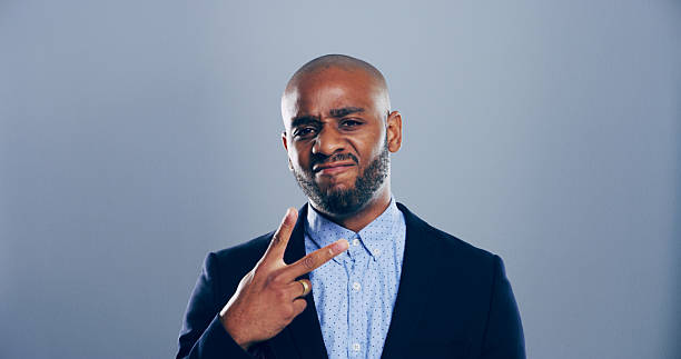 istock Portrait, confident and black man with peace sign in studio with arrogant attitude, mockup space or facial expression. Grey background, face and African male model for cool gesture, fashion or symbol 2215380707
