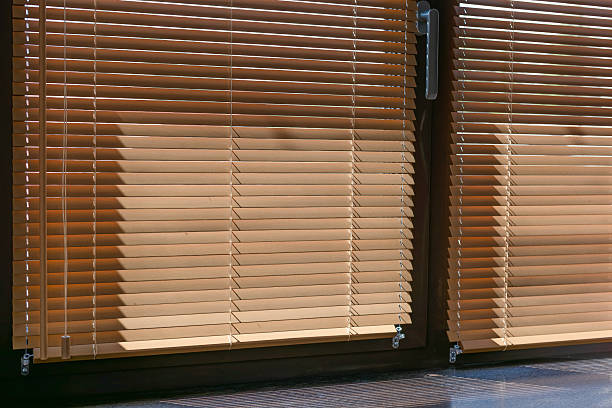 istock Warm Sunlight Through 25mm Wood Blinds 2215382356