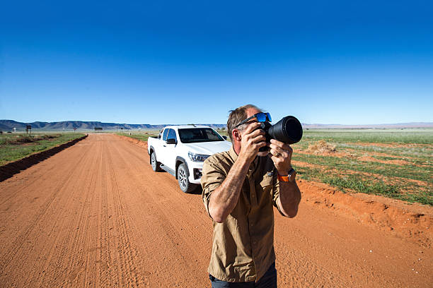 istock Photographer capturing an image while on the road trip 2215383313