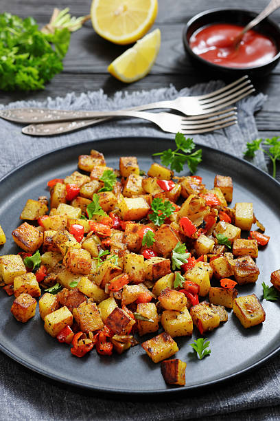 istock golden fried potatoes cubes with red bell pepper 2215383329