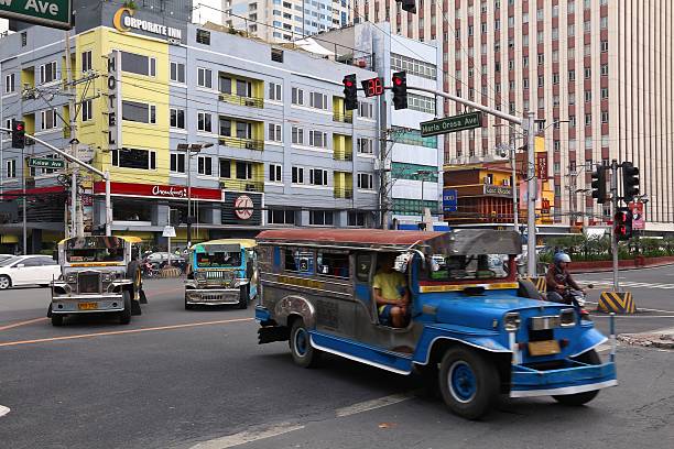 People ride a jeepney public transportation in heavy traffic in Manila, Philippines. Metro Manila is one of the biggest urban areas in the world with 24 million people.