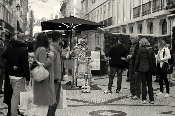 Lisbon, Portugal - November 19, 2022: A street artist performs as a living statue at the Rua Augusta street in Lisbon downtown.