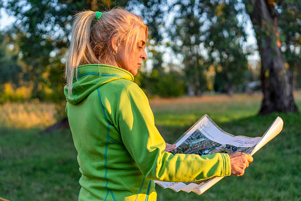 istock Outdoor woman explorer studying a map in scenic landscape 2215406437