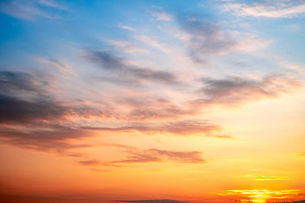 istock Sky,sunset, beautiful , luxury soft gradient orange gold clouds and sunlight on the blue sky perfect for the background, Sunrise on morning or everning in winter warm time ,Twilight summer,silhouette 2215408436