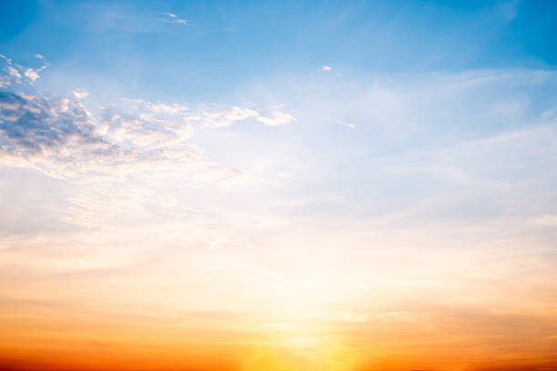 istock Sky,sunset, beautiful , luxury soft gradient orange gold clouds and sunlight on the blue sky perfect for the background, Sunrise on morning or everning in winter warm time ,Twilight summer,silhouette 2215408458