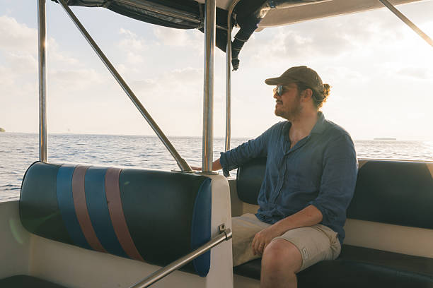 istock Young man relaxes on yacht 2215409125