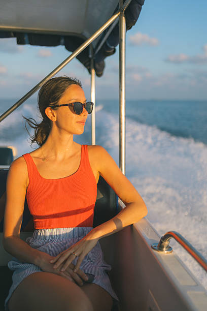 istock Young woman relaxes on yacht 2215409251