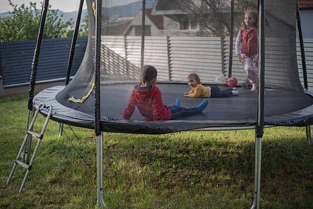 istock Little children are playing on a trampoline 2215409273
