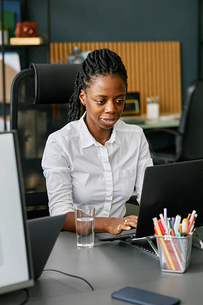 istock Focused Young Woman Working in Office Setting 2215409603
