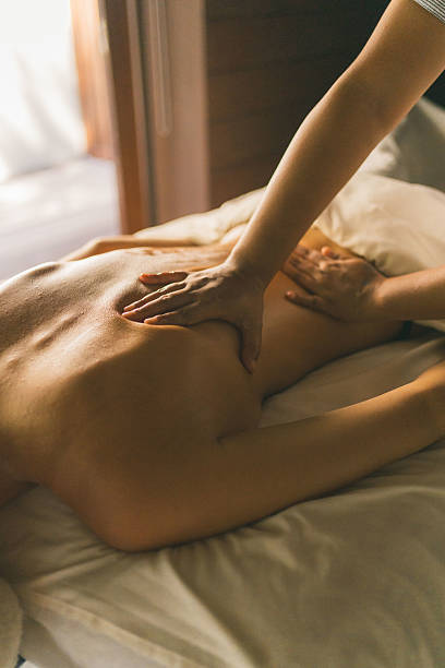 Young woman enjoys massage treatment