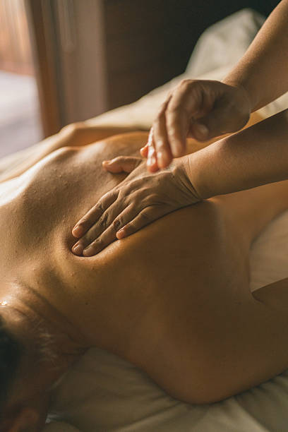 istock Young woman enjoys massage treatment 2215410726