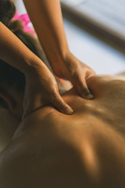 istock Young woman enjoys massage treatment 2215410855