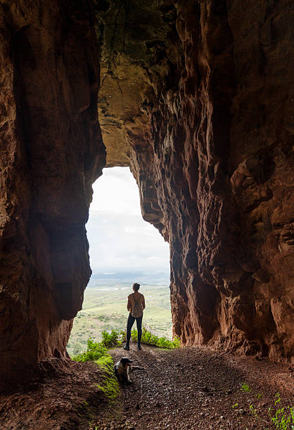 istock Female hiker admiring landscape through mountain window 2215411051